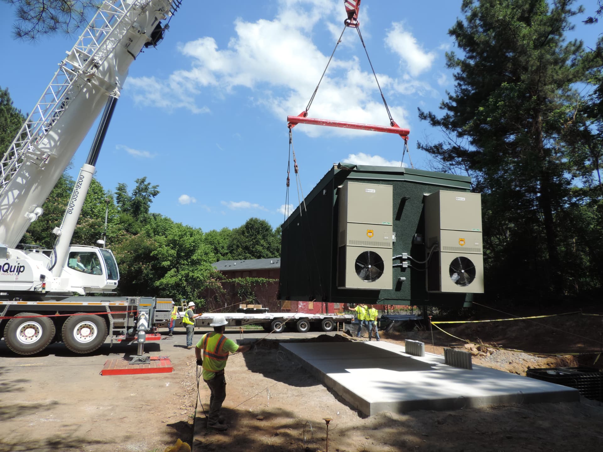 Crane setting a modular infrastructure unit on site